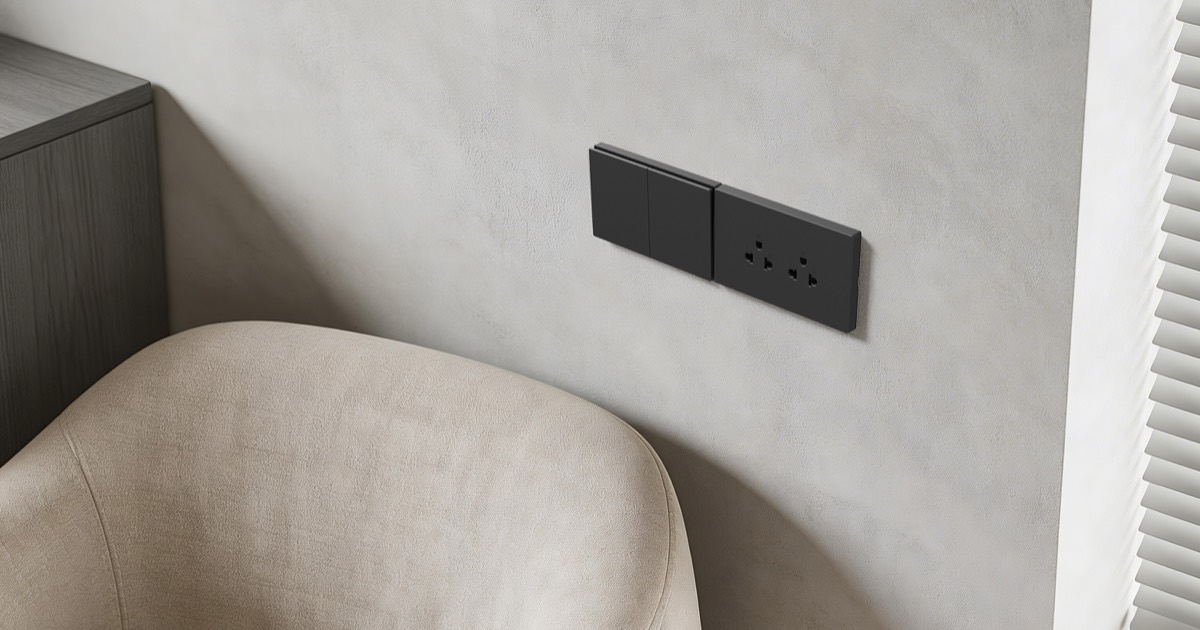 Black MG37 switch and socket beside a chair